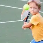 child playing tennis at the apex tennis center