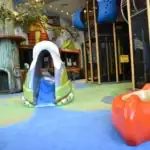 indoor playground with canoe and slide.