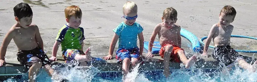 A group of young boys playing in a pool