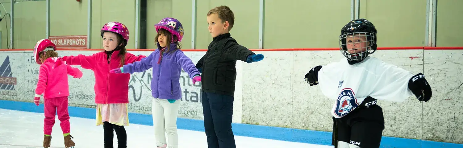 a group of kids ice skating
