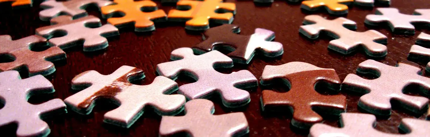 A group of puzzle pieces sitting on top of a table.