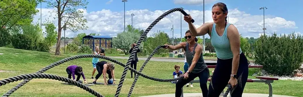Several people are exercising outdoors in a park