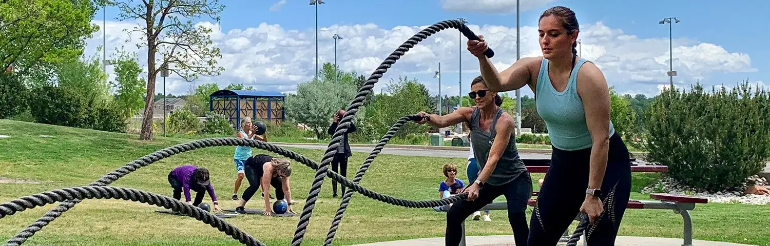 Several people are exercising outdoors in a park