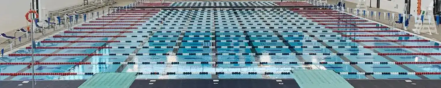 Arvada Aquatics Center view from diving board overlooking indoor pools.