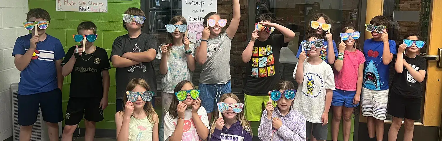 A group of children wearing decorated glasses.