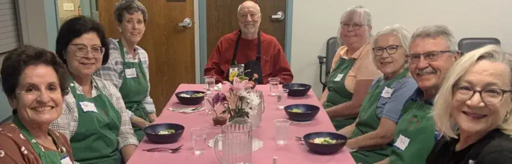 A group of individuals sitting around a dinner table.