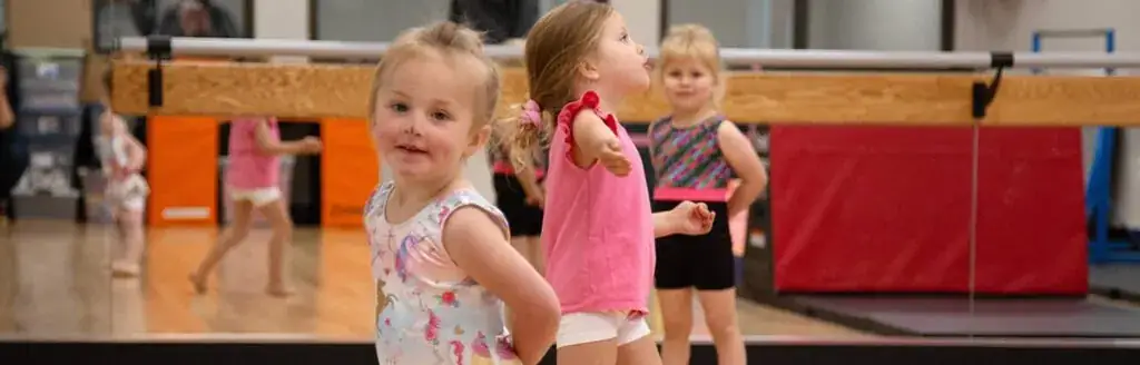 Young children dancing in a dance studio.