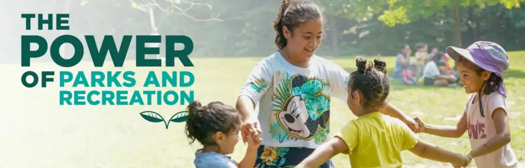 Children holding hands and playing in a sunny park, with "The Power of Parks and Recreation" text on the left side.