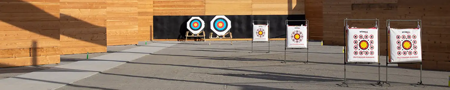 An archery range featuring wooden walls and colorful targets.